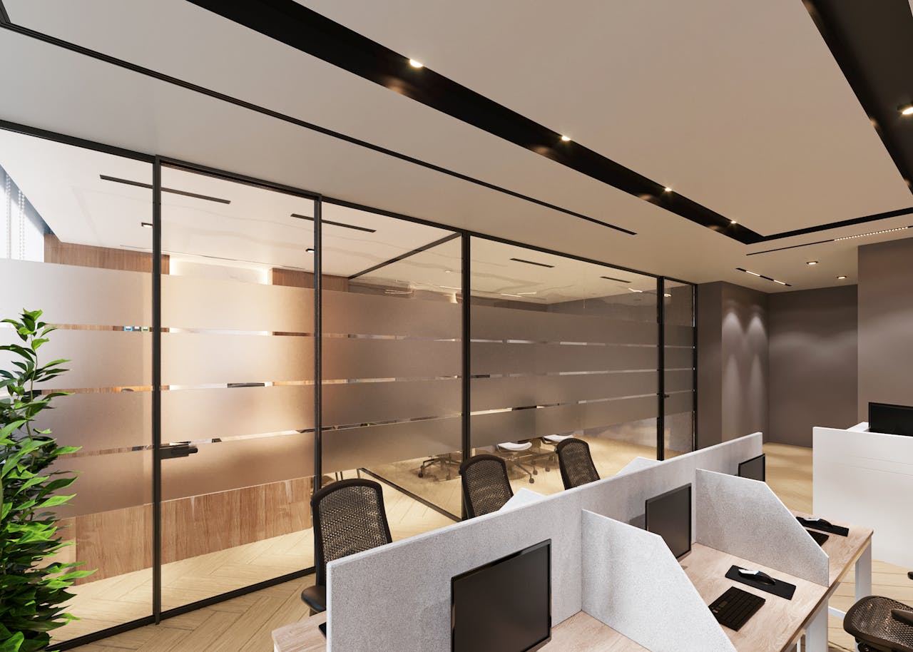 home-services-03 Contemporary office space featuring sleek cubicles and large glass partitions for an open ambiance.
