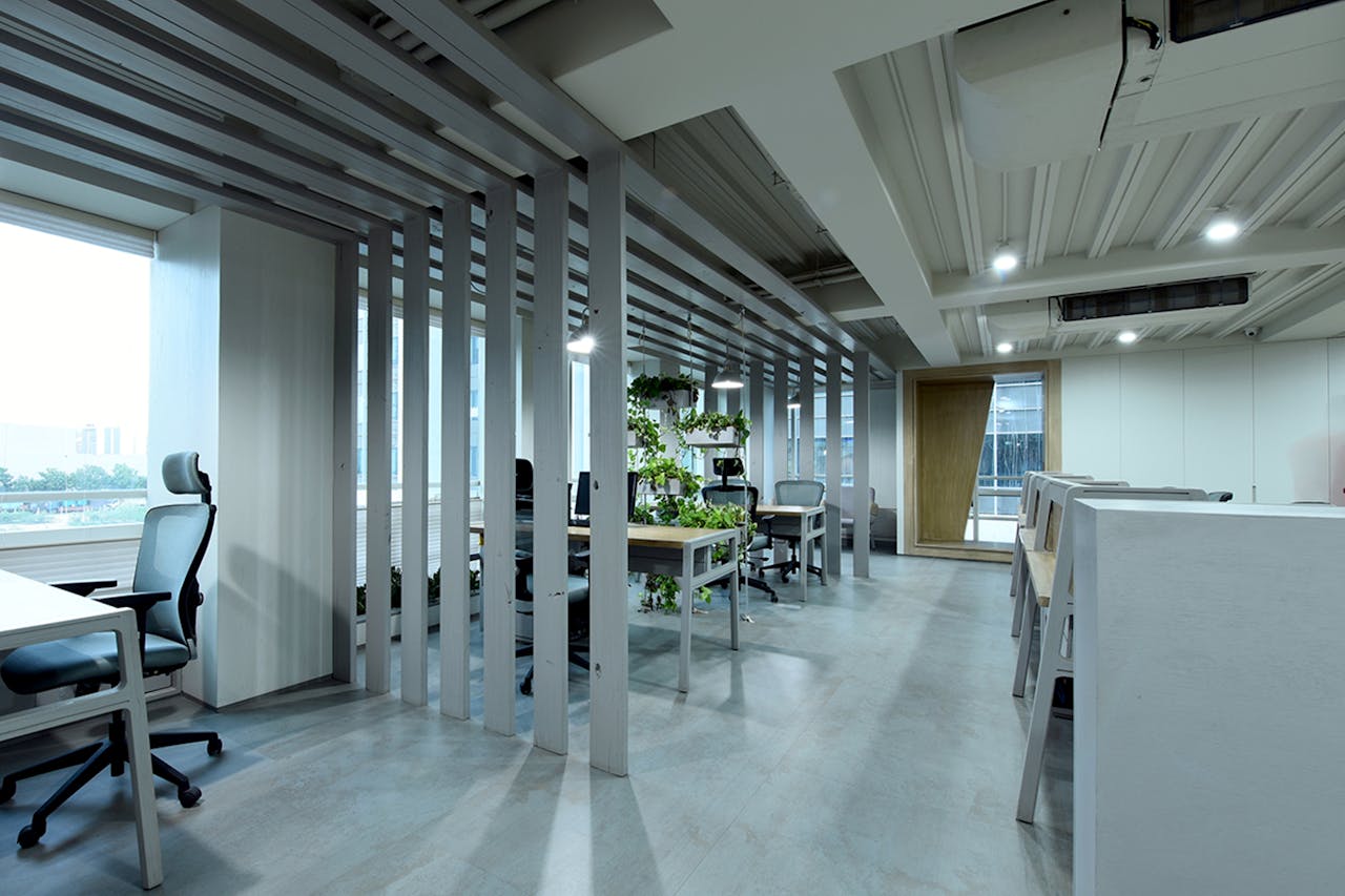cta-bg Spacious modern office in Ahmedabad with an open design and indoor plants.